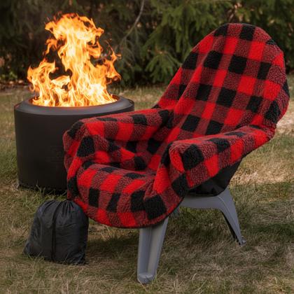 A quilted seat cushion on a camp chair beside a fire