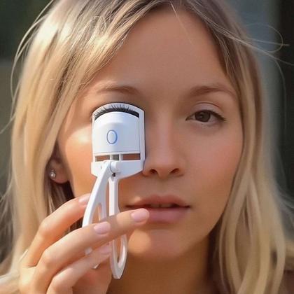 Someone using a handheld eyelash curler