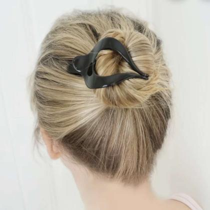A hair clip holding a bun in place