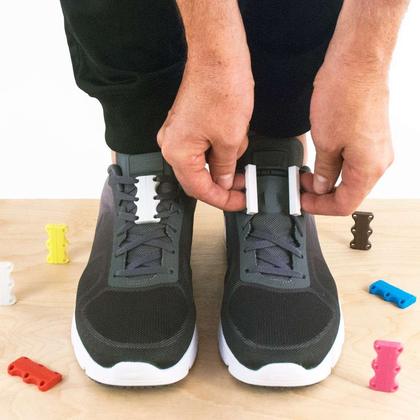 No-tie elastic lace anchors being fitted to a pair of sneakers